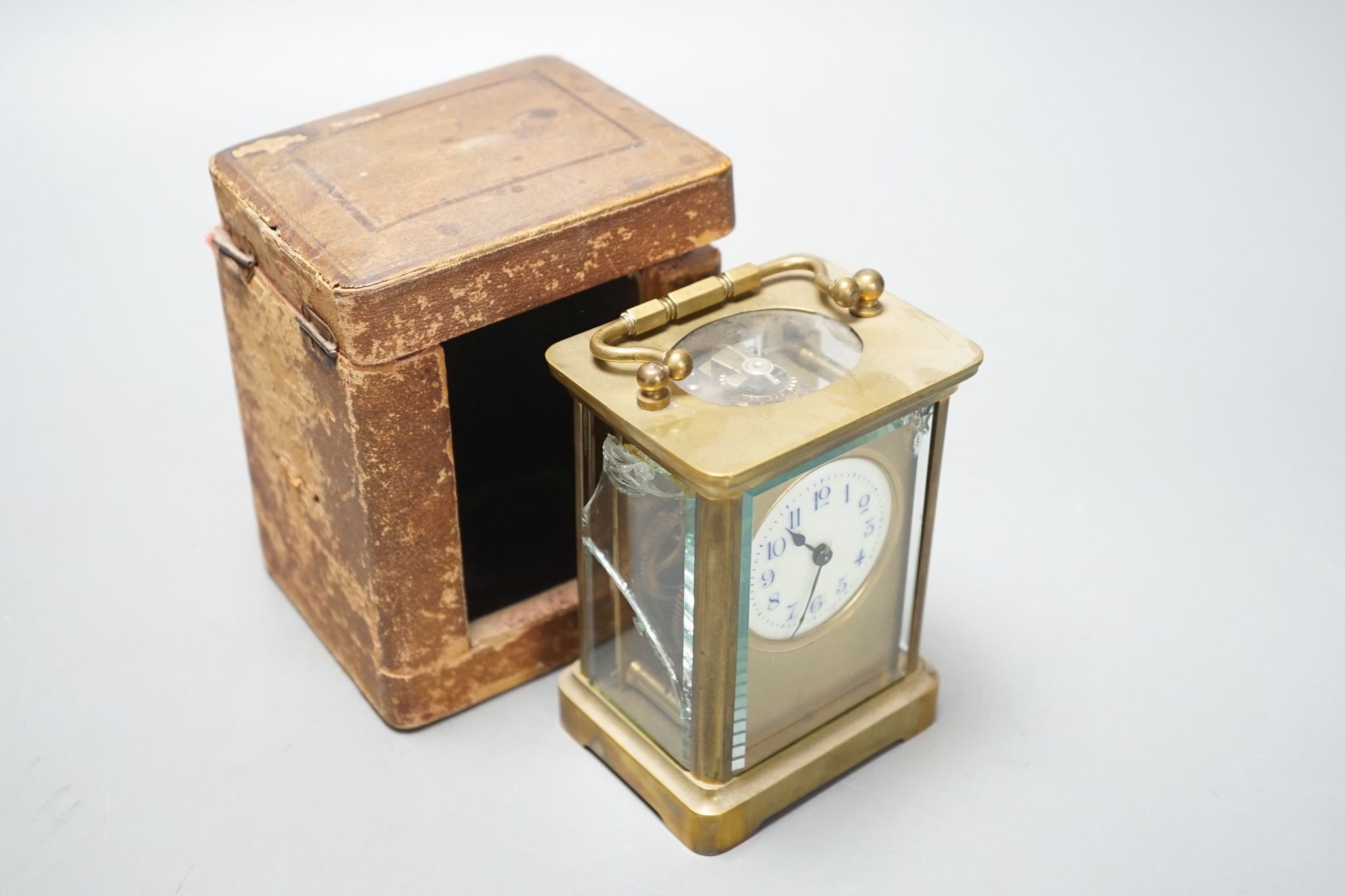 A cased brass carriage timepiece, 10.5 cms high high not including case.